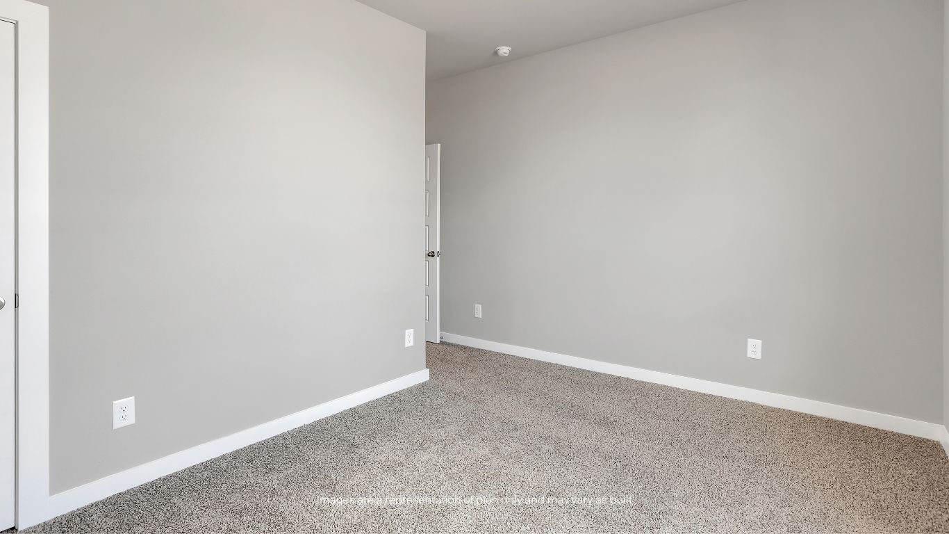 Bright and welcoming, this secondary bedroom offers plenty of space for a guest room, nursery, office, or hobby room.