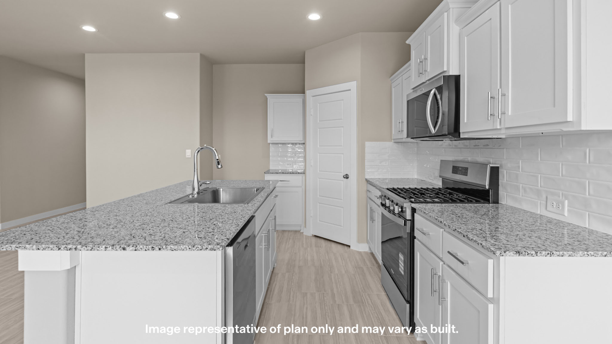 Open concept kitchen with stainless steel appliances, shaker style cabinets, and elevated finishes