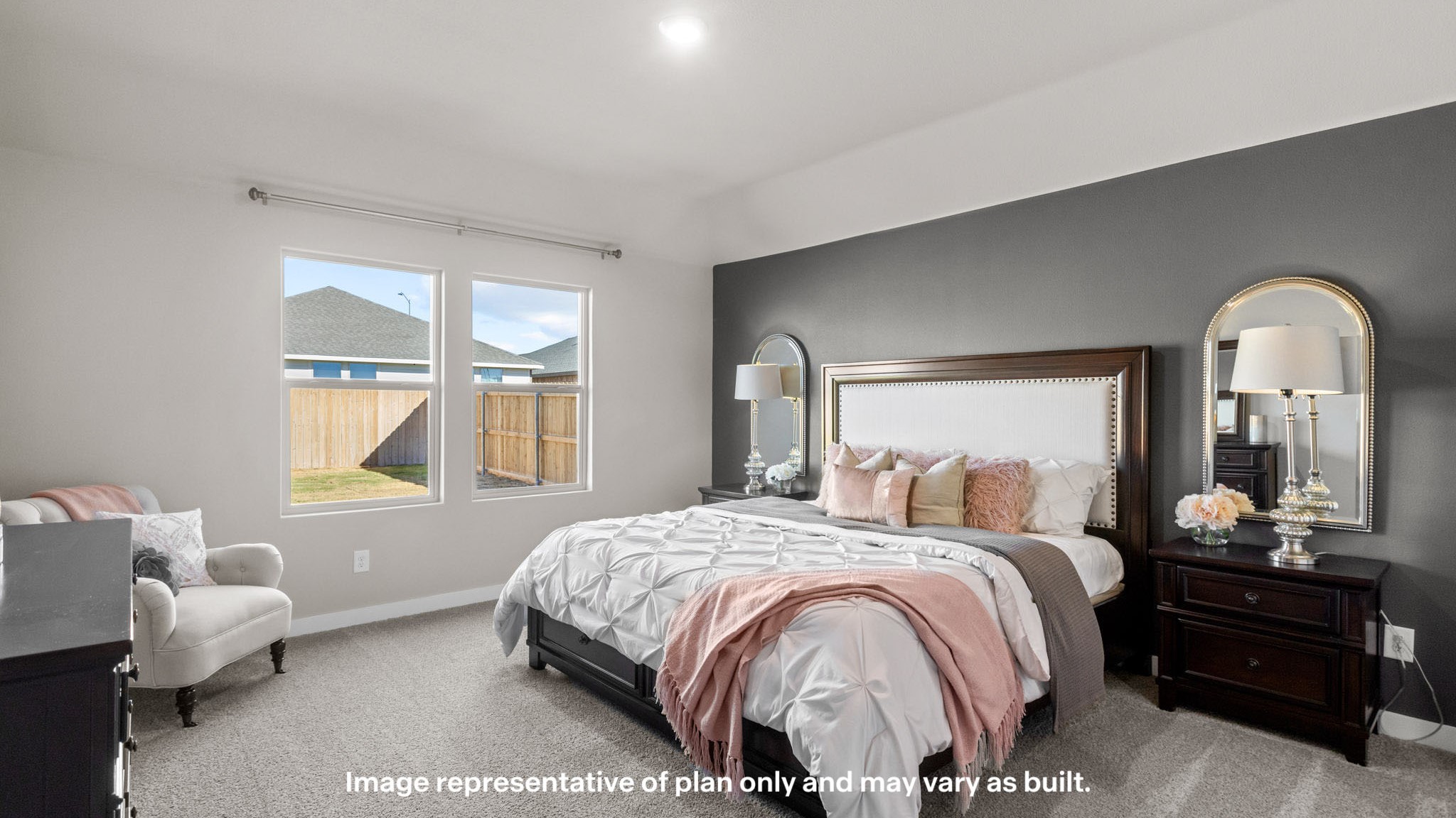 Primary bedroom with plush carpet floors and light allowing double windows