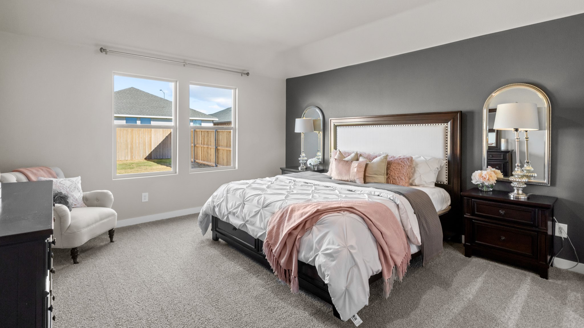 Primary bedroom with plush carpet floors and light allowing double windows