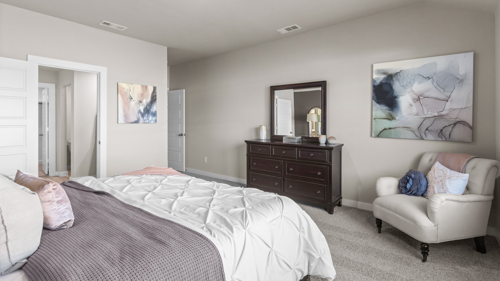 Primary bedroom with private attached bathroom and walk-in closet