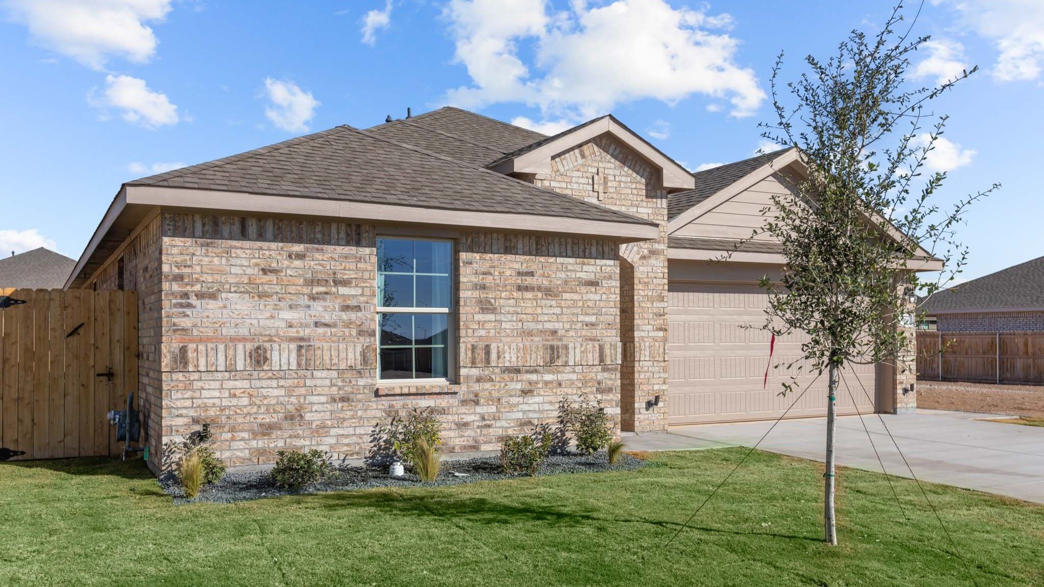 Side view of single story timeless brick home