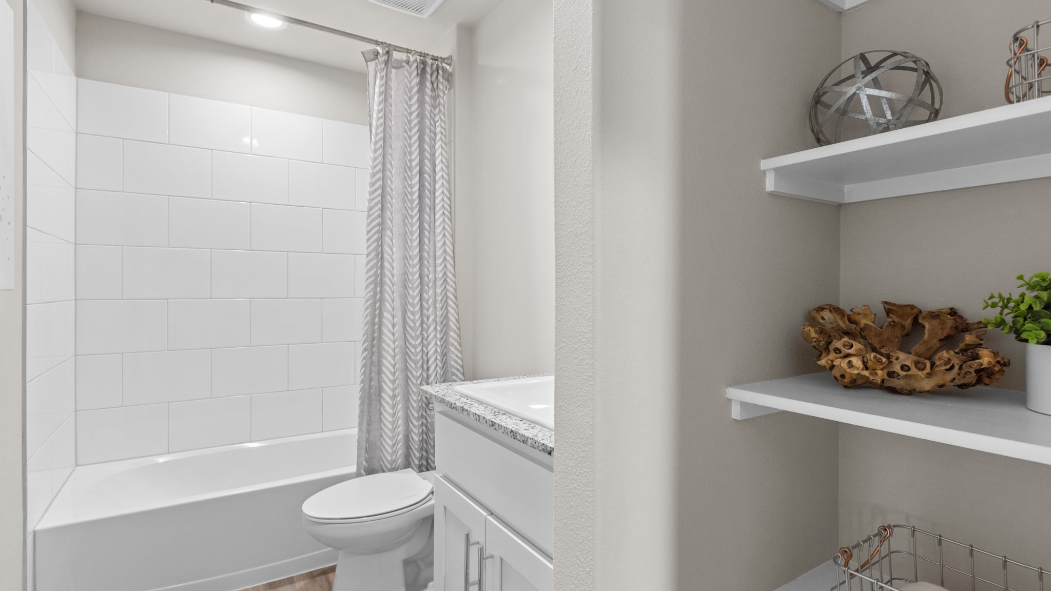 Guest bathroom with built in vanity and combination bathtub shower