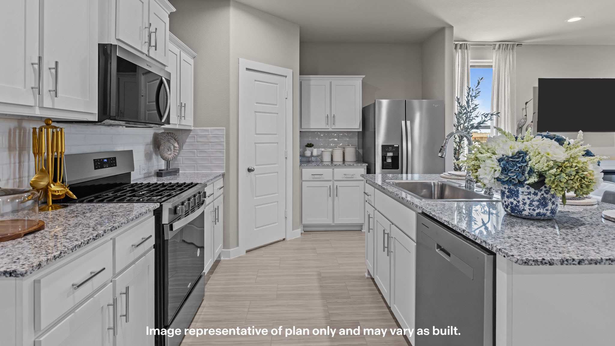 Open concept kitchen with stainless steel appliances, shaker style cabinets, and elevated finishes