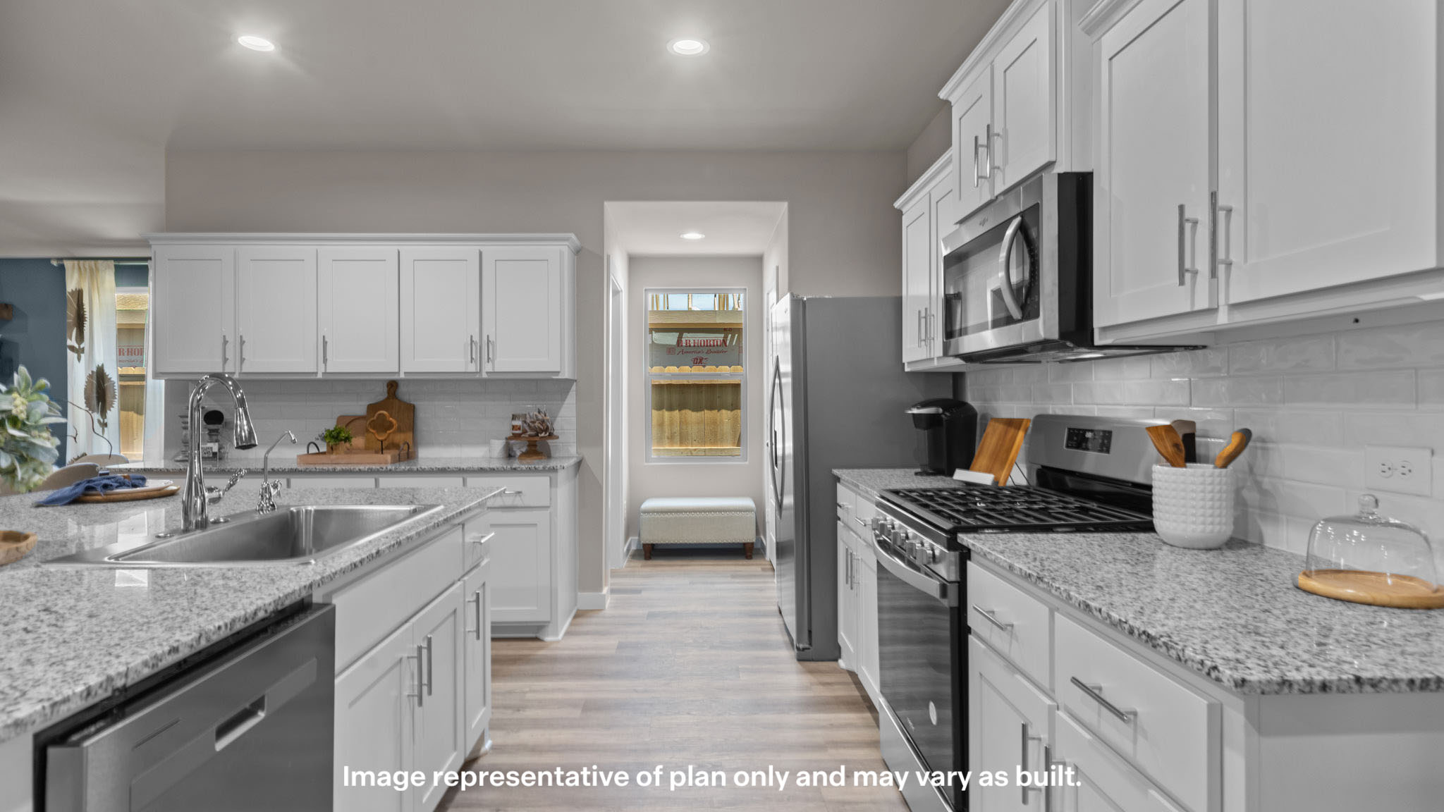 Open concept kitchen with stainless steel appliances, shaker style cabinets, and elevated finishes