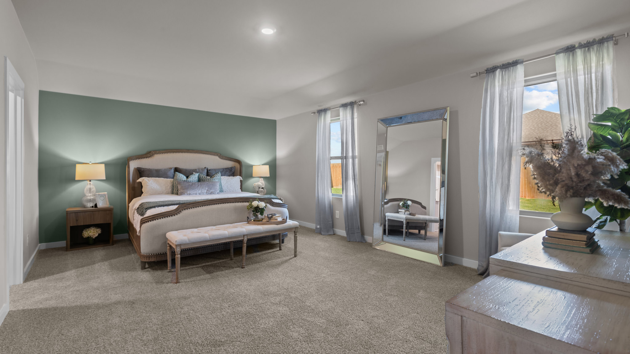 Primary bedroom with plush carpet floors and light allowing double windows