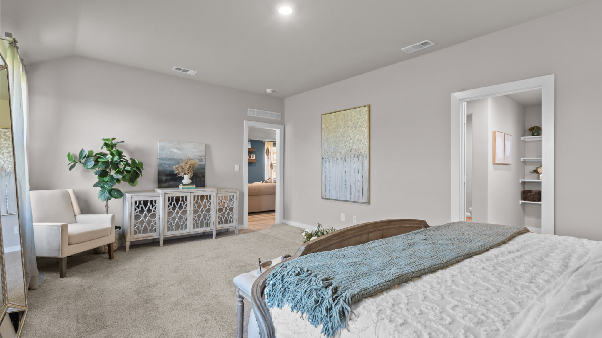 Primary bedroom with private attached bathroom and walk-in closet