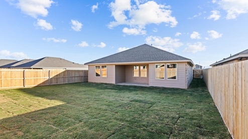 Spacious green lawn and backyard single-story brick the home