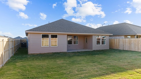 Covered back patio area overlooking spacious lawn