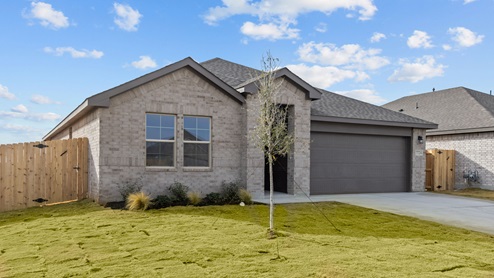Exterior of one-story timeless brick home with tan brick