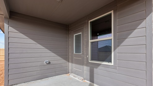 Covered back patio area overlooking backyard