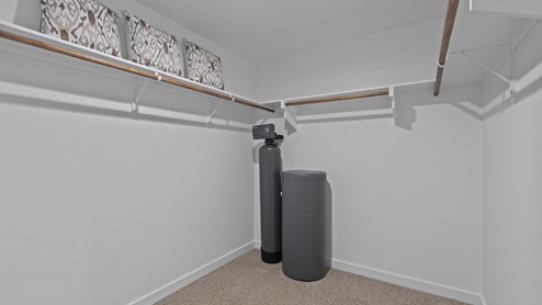 Primary walk-in closet attached to primary bathroom and primary bedroom