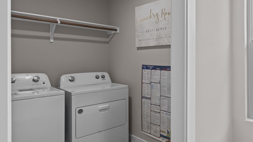 Utility closet and laundry room area situated to side of kitchen