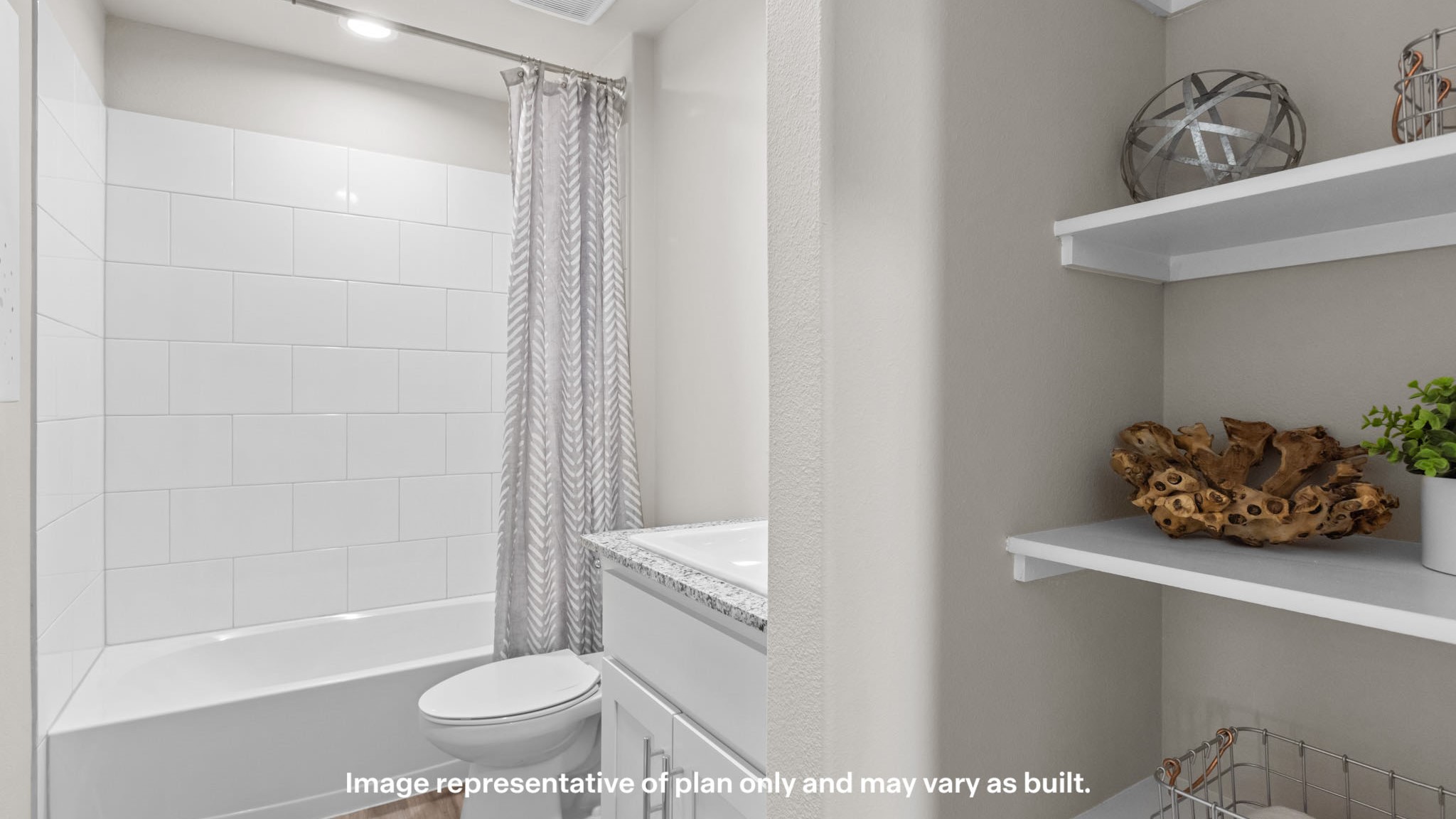 Guest bathroom with tiled shower, vanity, and built in storage shelves