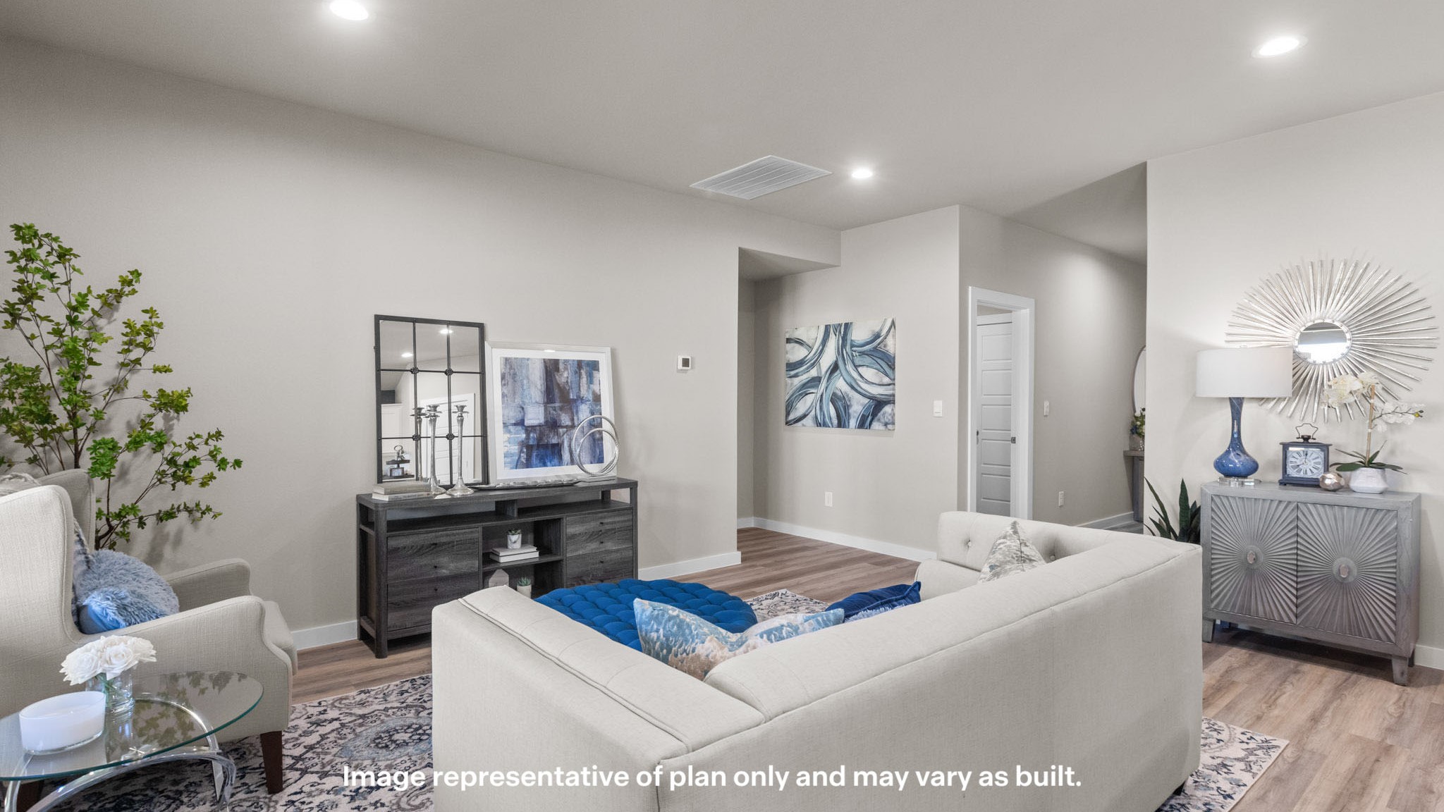 Welcoming living and family room area with light color decor and blue accents