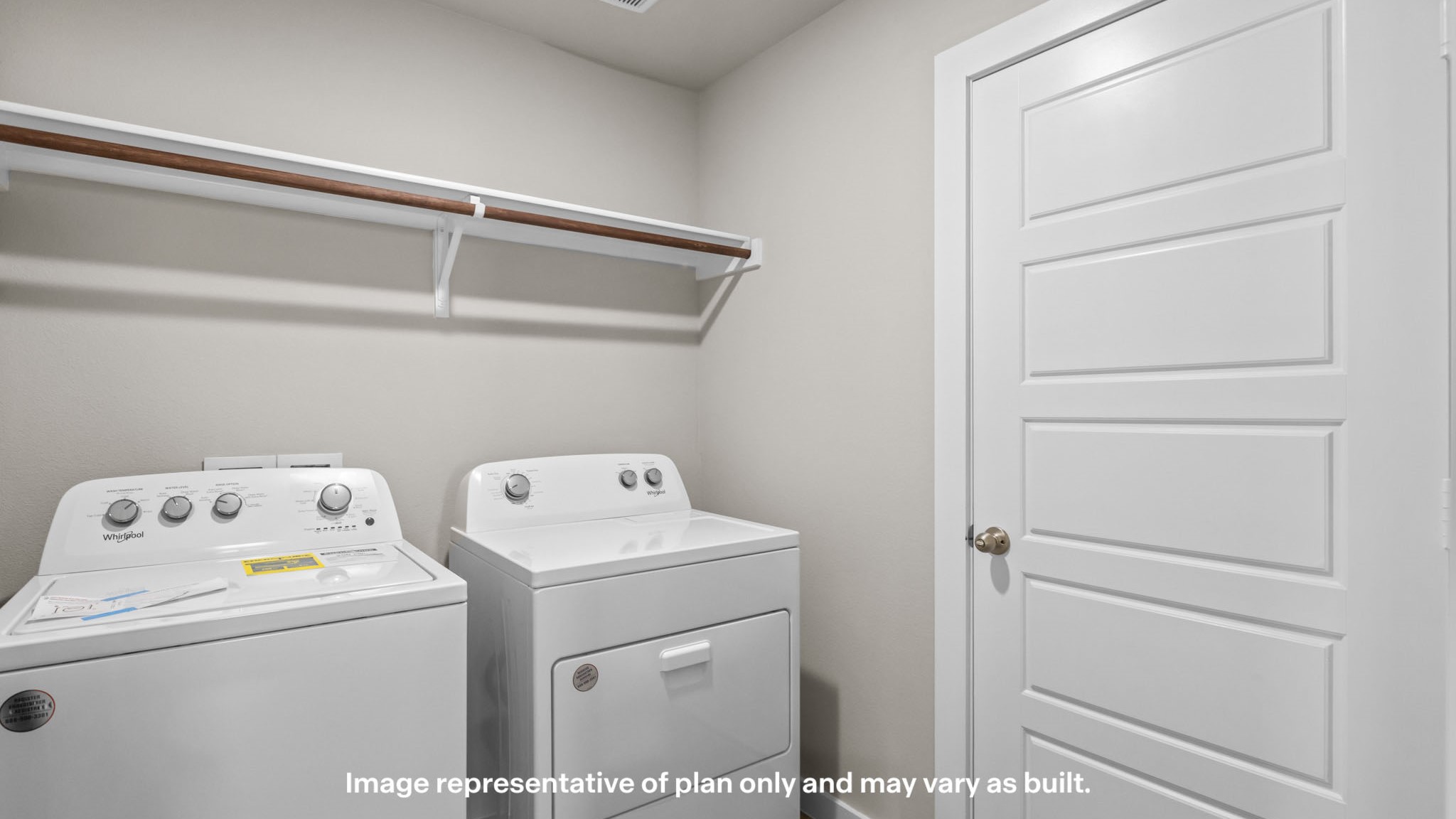 Laundry room with hanging rod and extra storage.