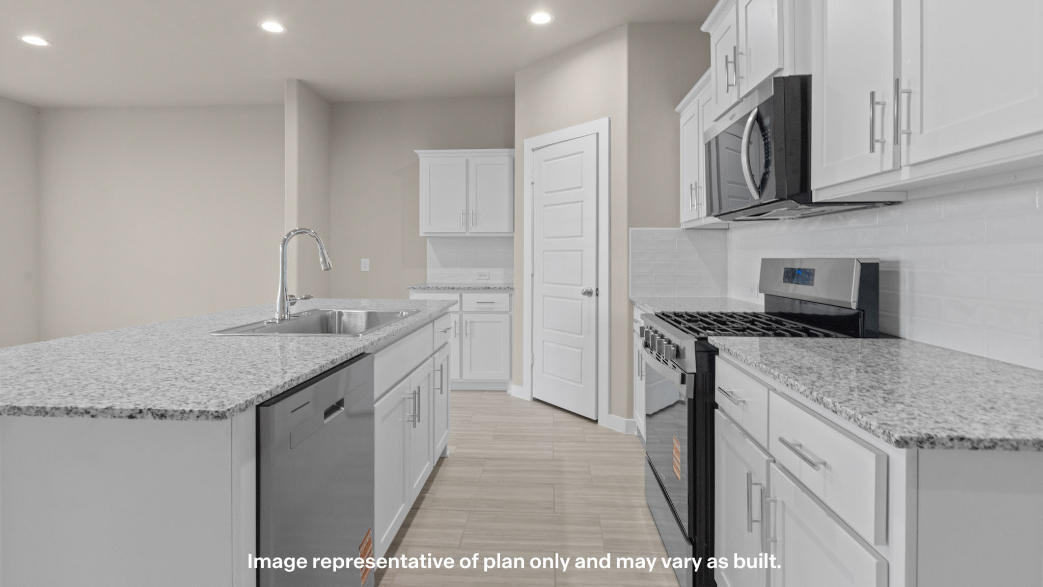 Open concept kitchen with stainless steel appliances, shaker style cabinets, and elevated finishes