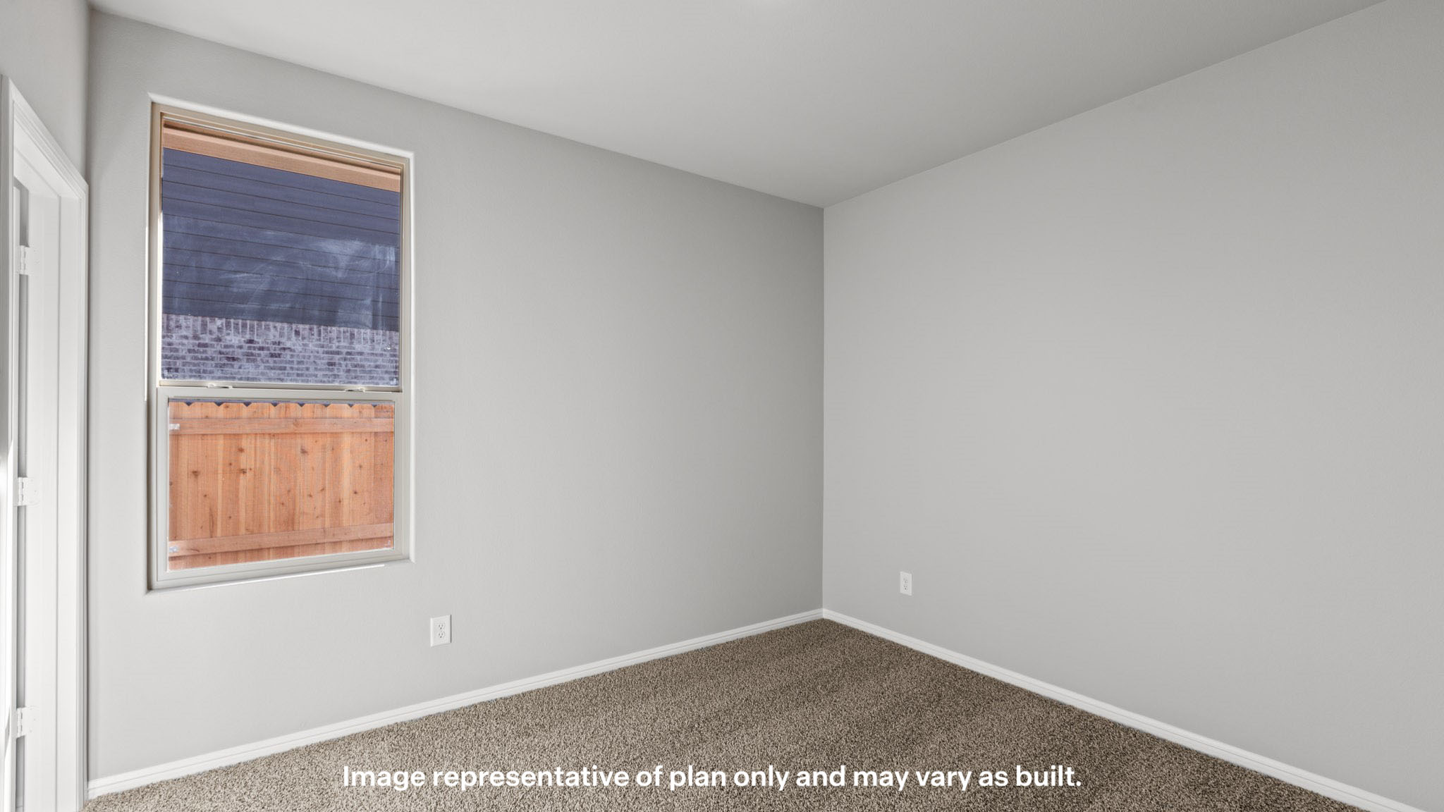 Guest bedroom 2 with side window and plush carpet floor