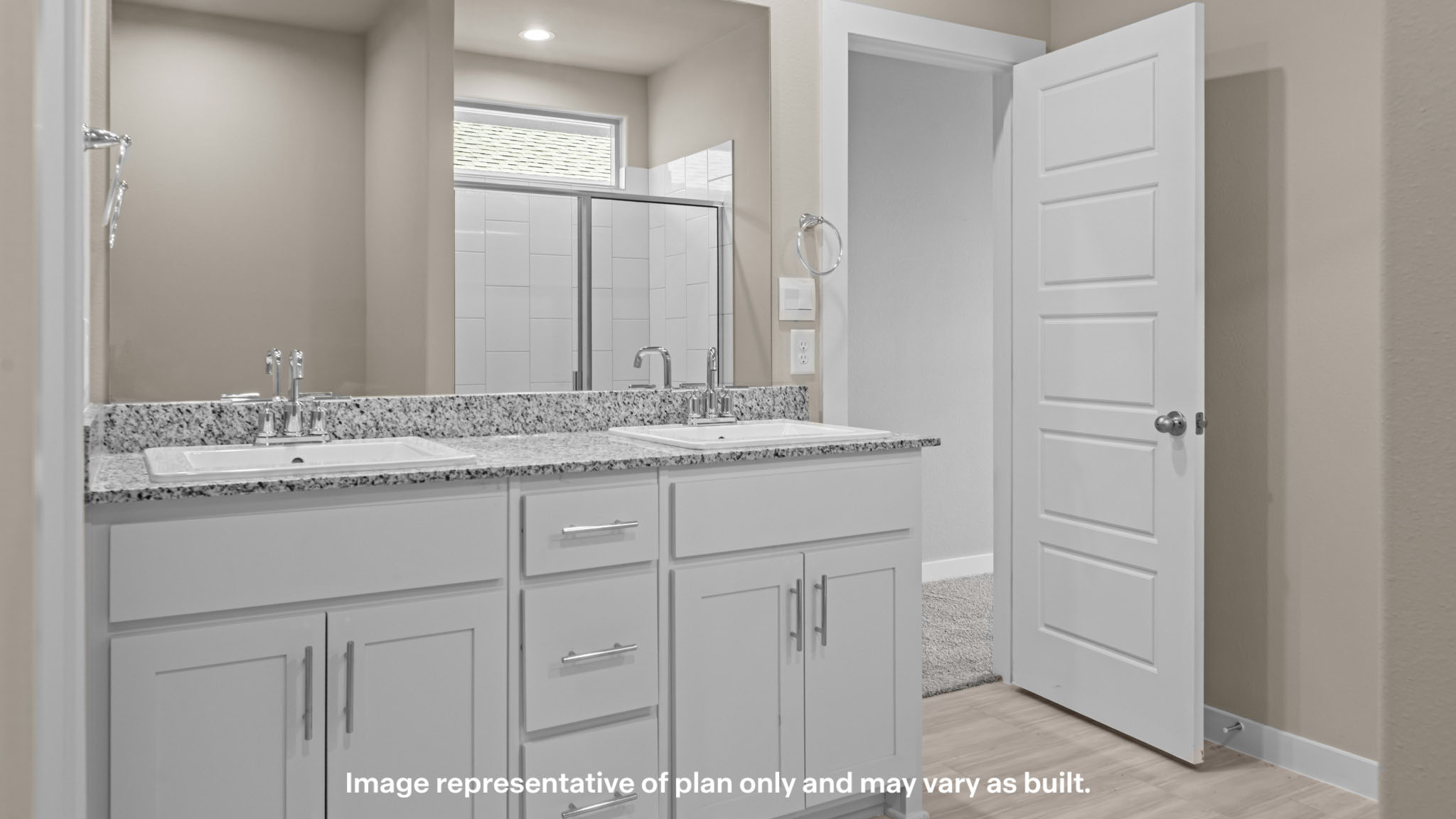 Primary bathroom featuring dual vanities and modern finishes.