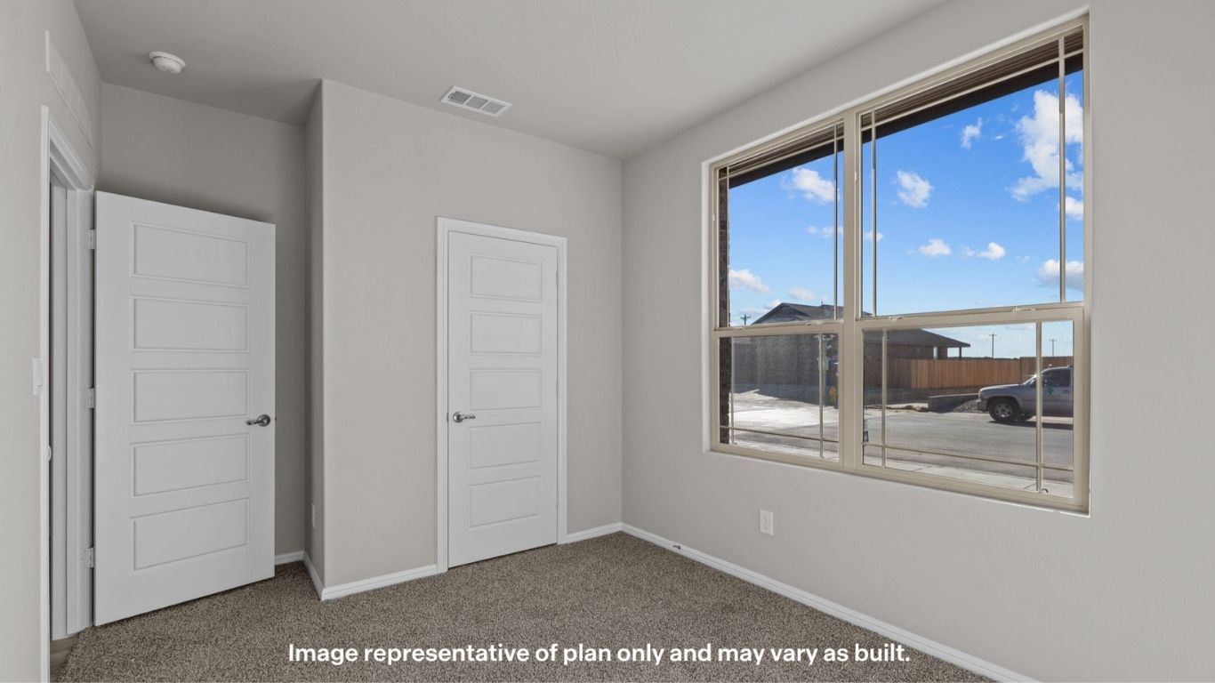 Walk-in closet with built-in shelving and storage space.