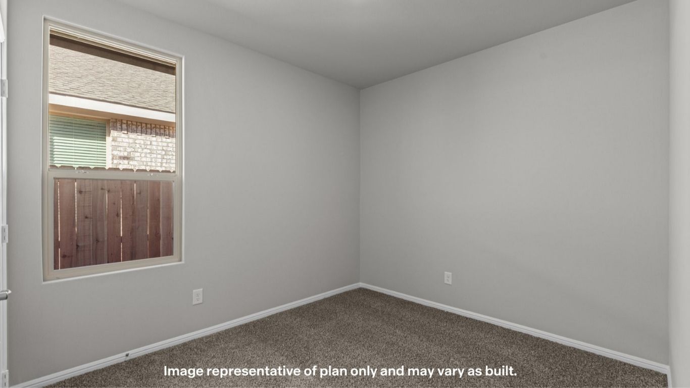 Secondary bedroom with front-facing window and natural light.