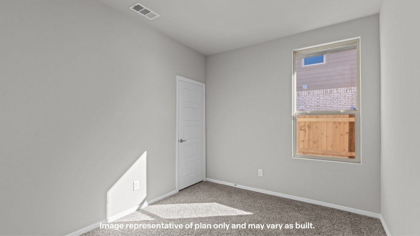 Secondary bedroom with closet access and clean design.