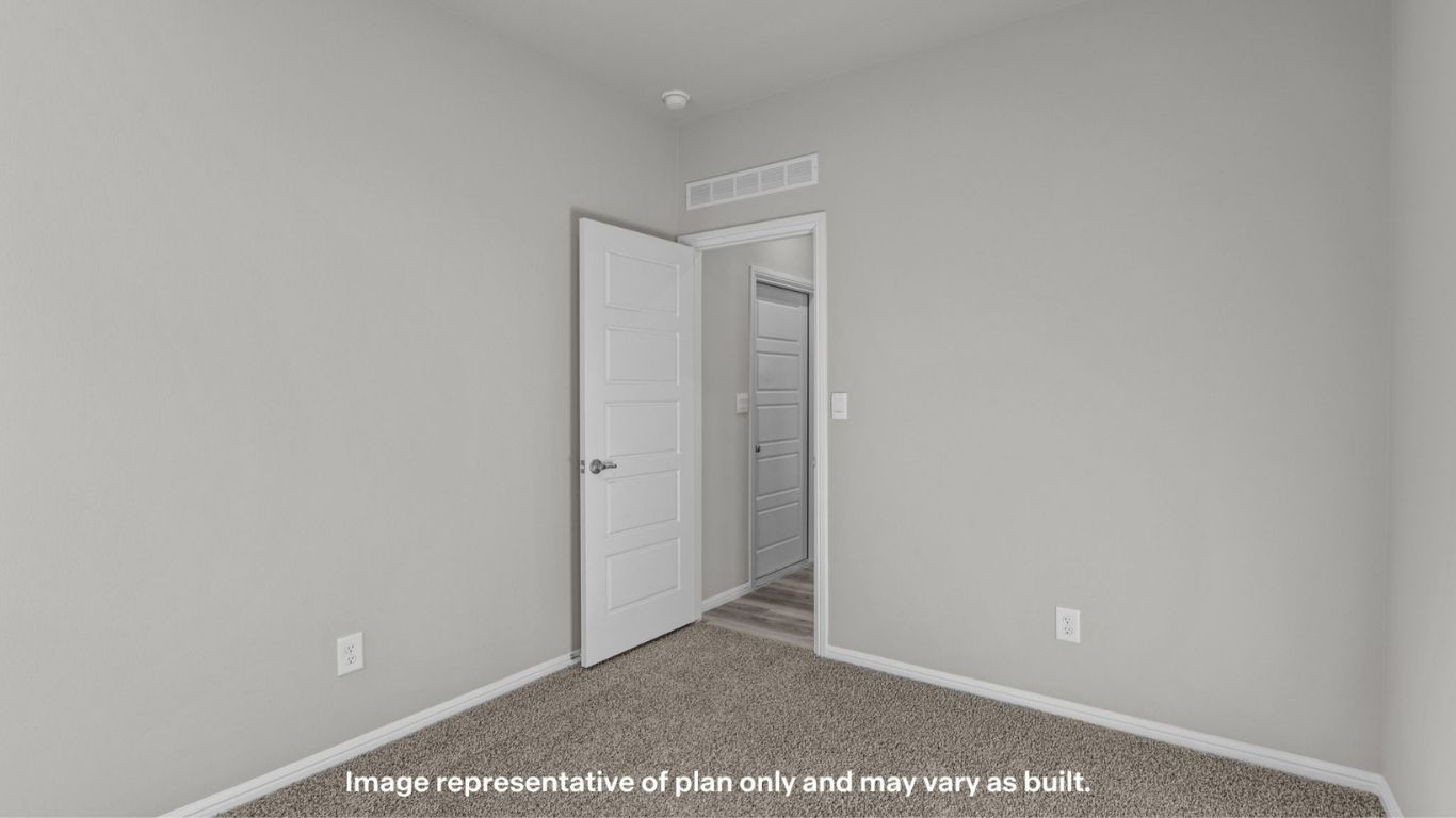 Additional bedroom with soft carpet and bright window.