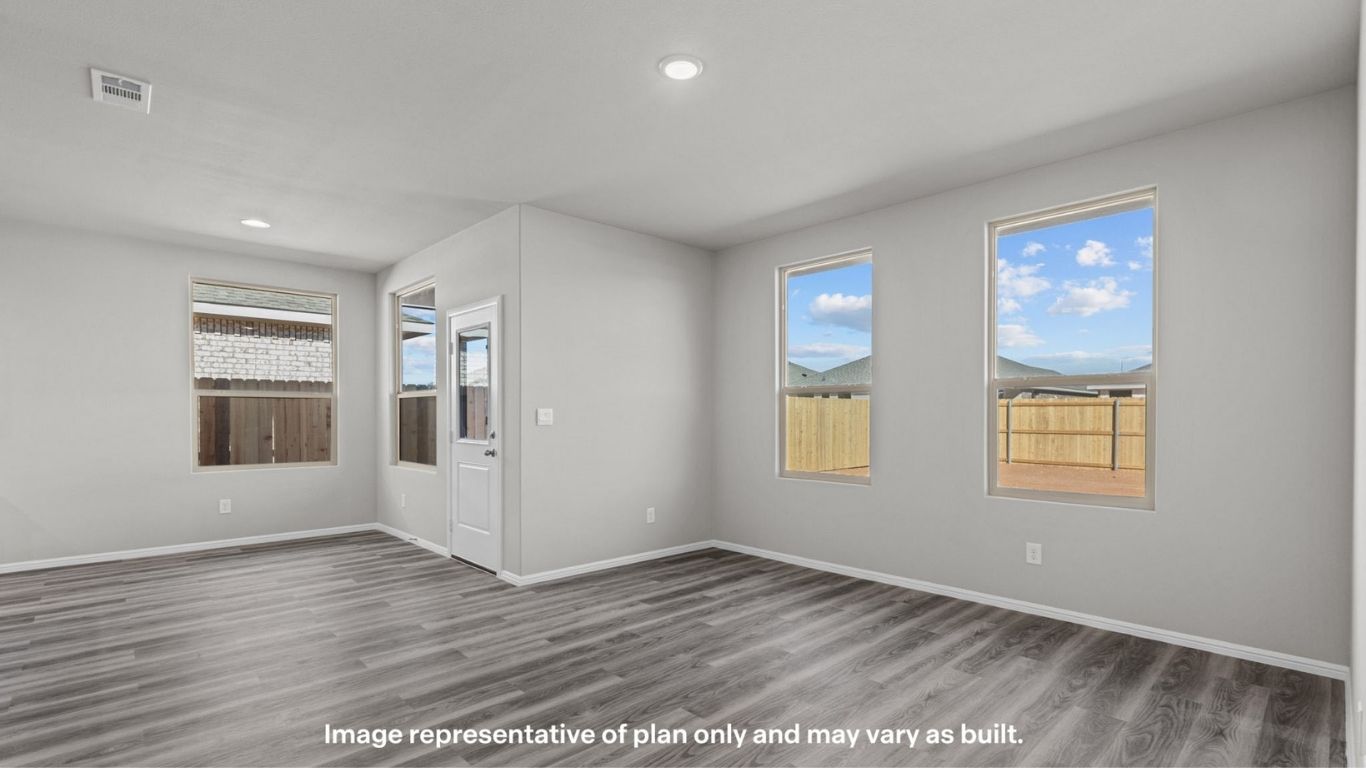 Dining area with natural light and backyard access.