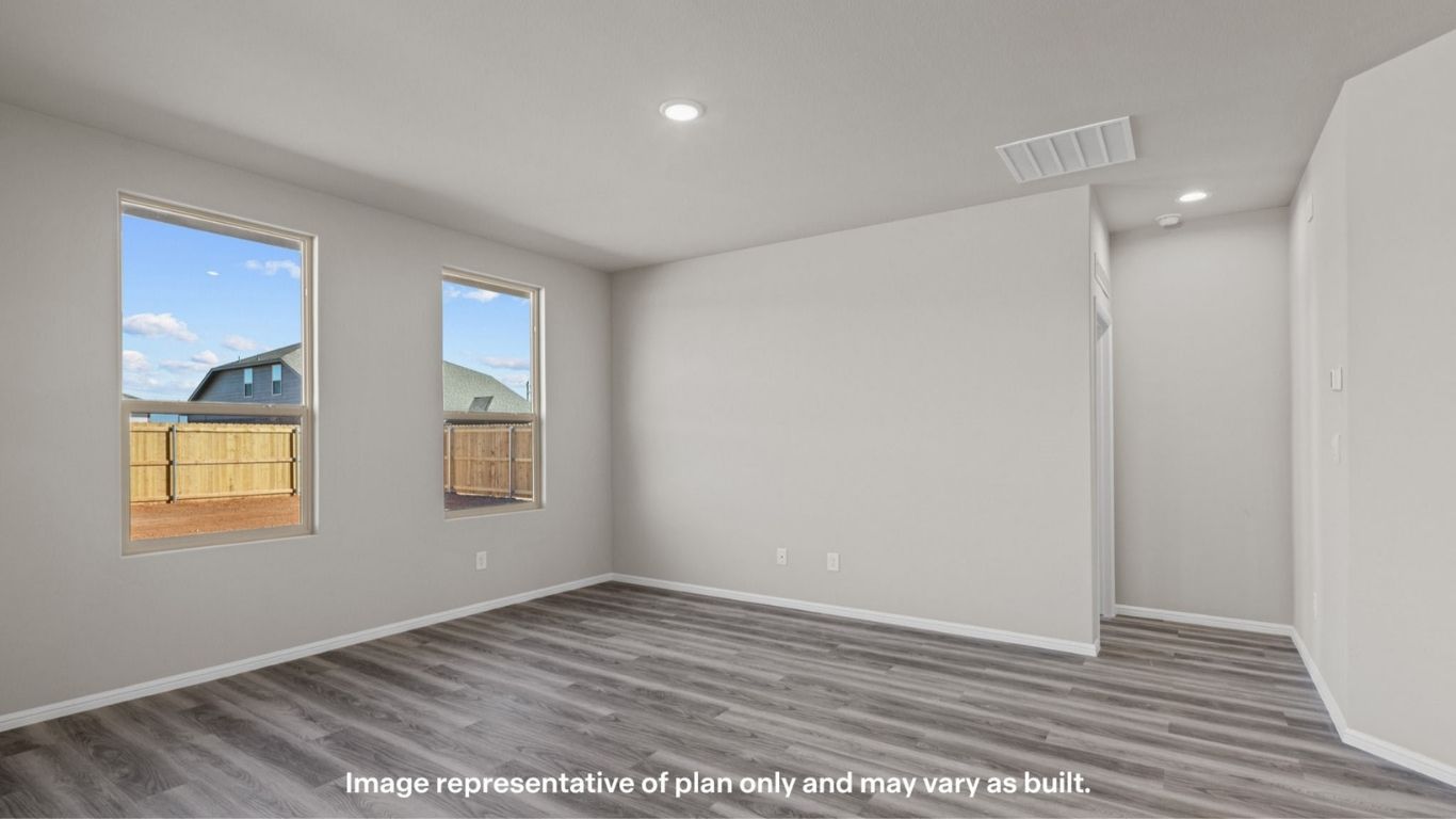 Open-concept living and dining space with large windows.