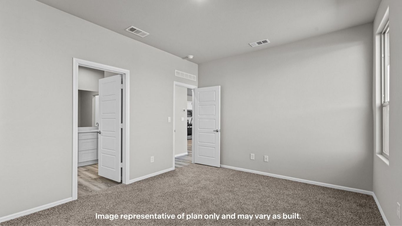 Primary bedroom with private attached bathroom and walk-in closet