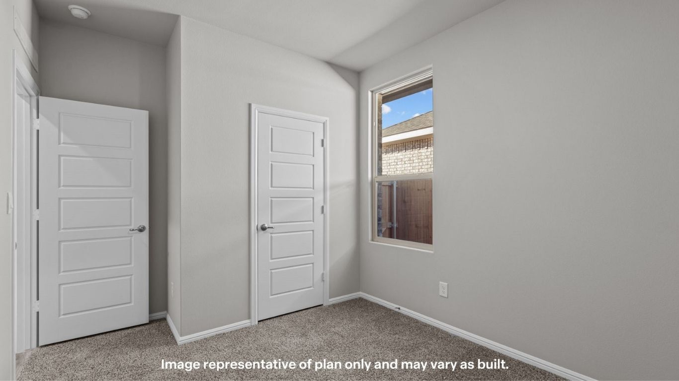 Guest bedroom 2 with side window and plush carpet floor