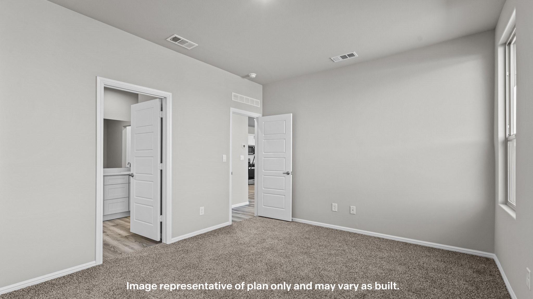 Primary bedroom with private attached bathroom and walk-in closet