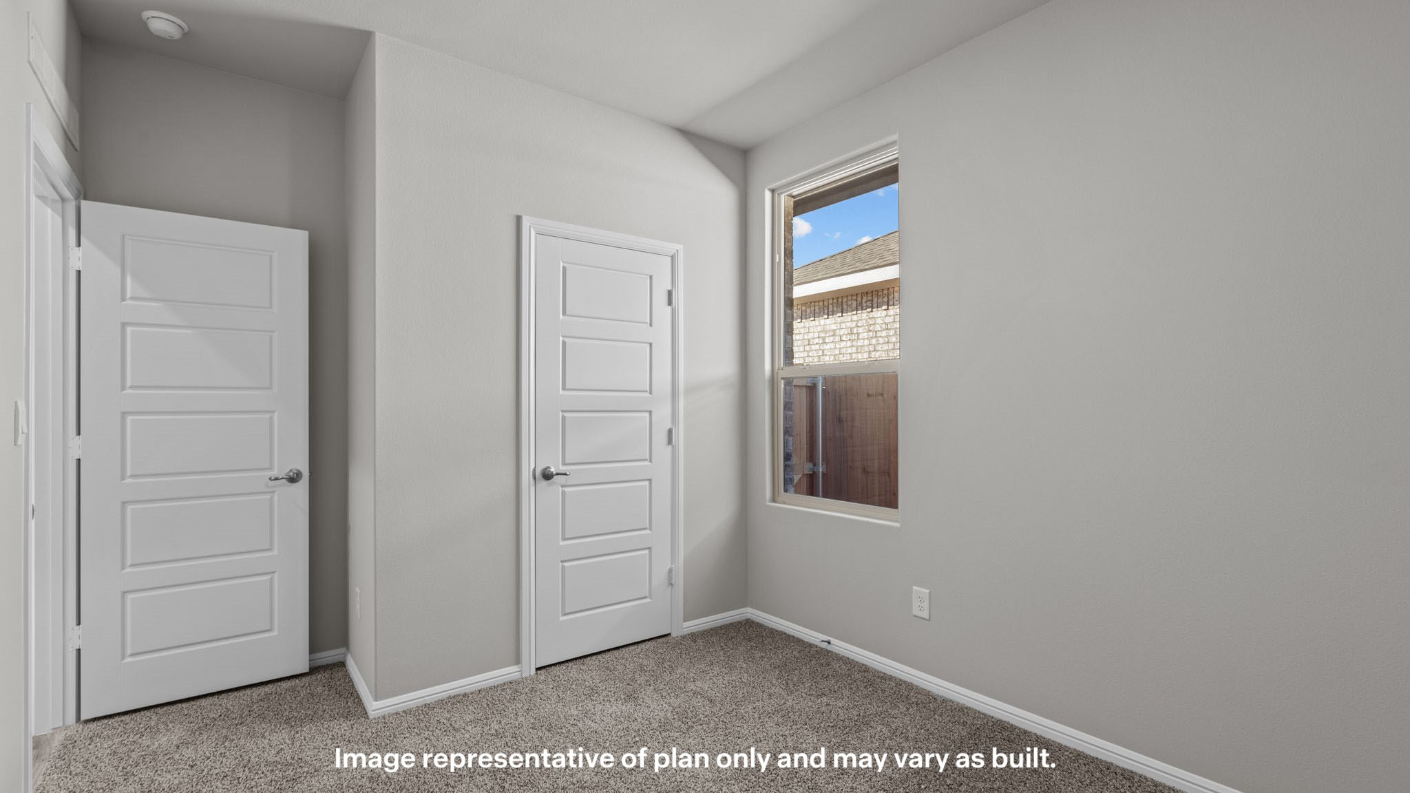 Guest bedroom 2 with side window and plush carpet floor