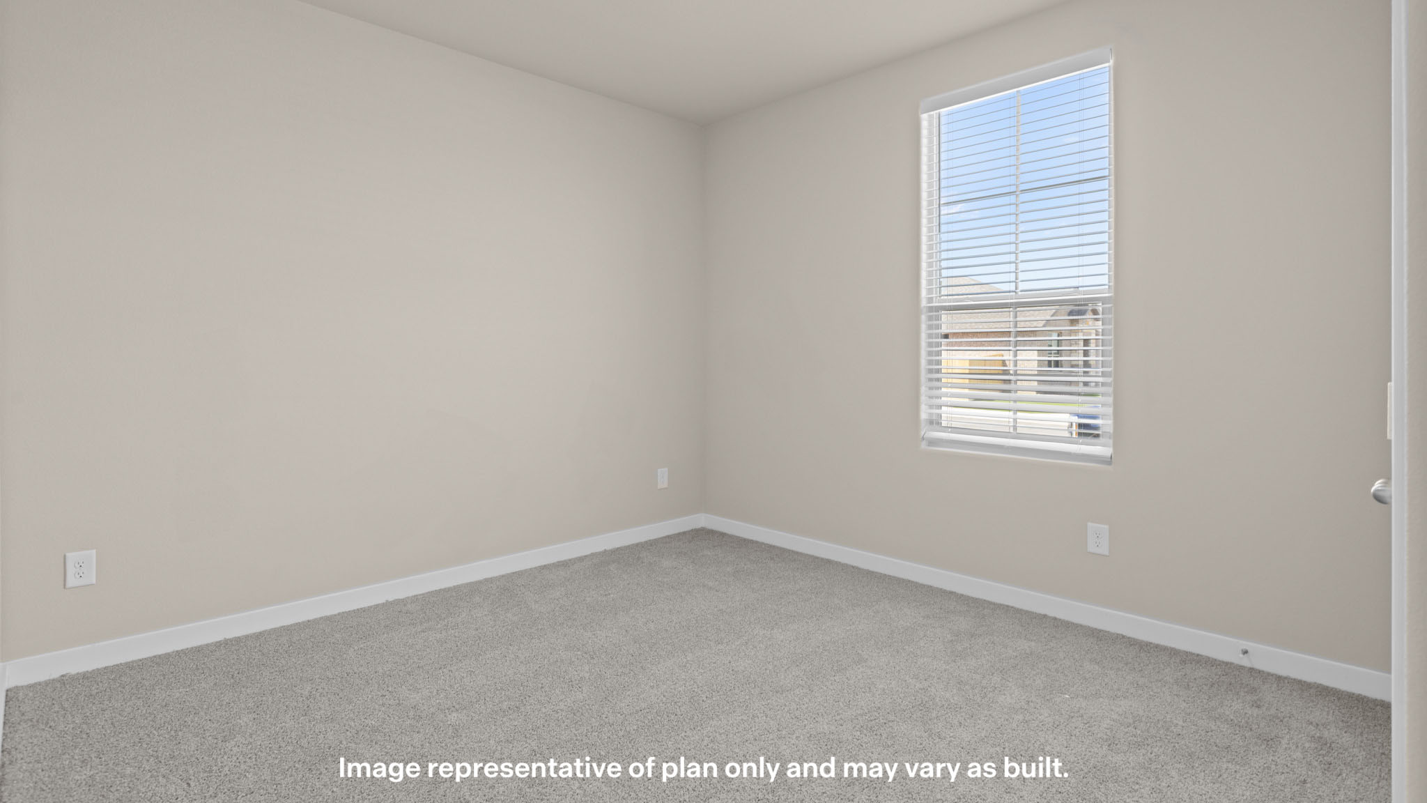 Secondary bedroom featuring plush carpeting and natural light.