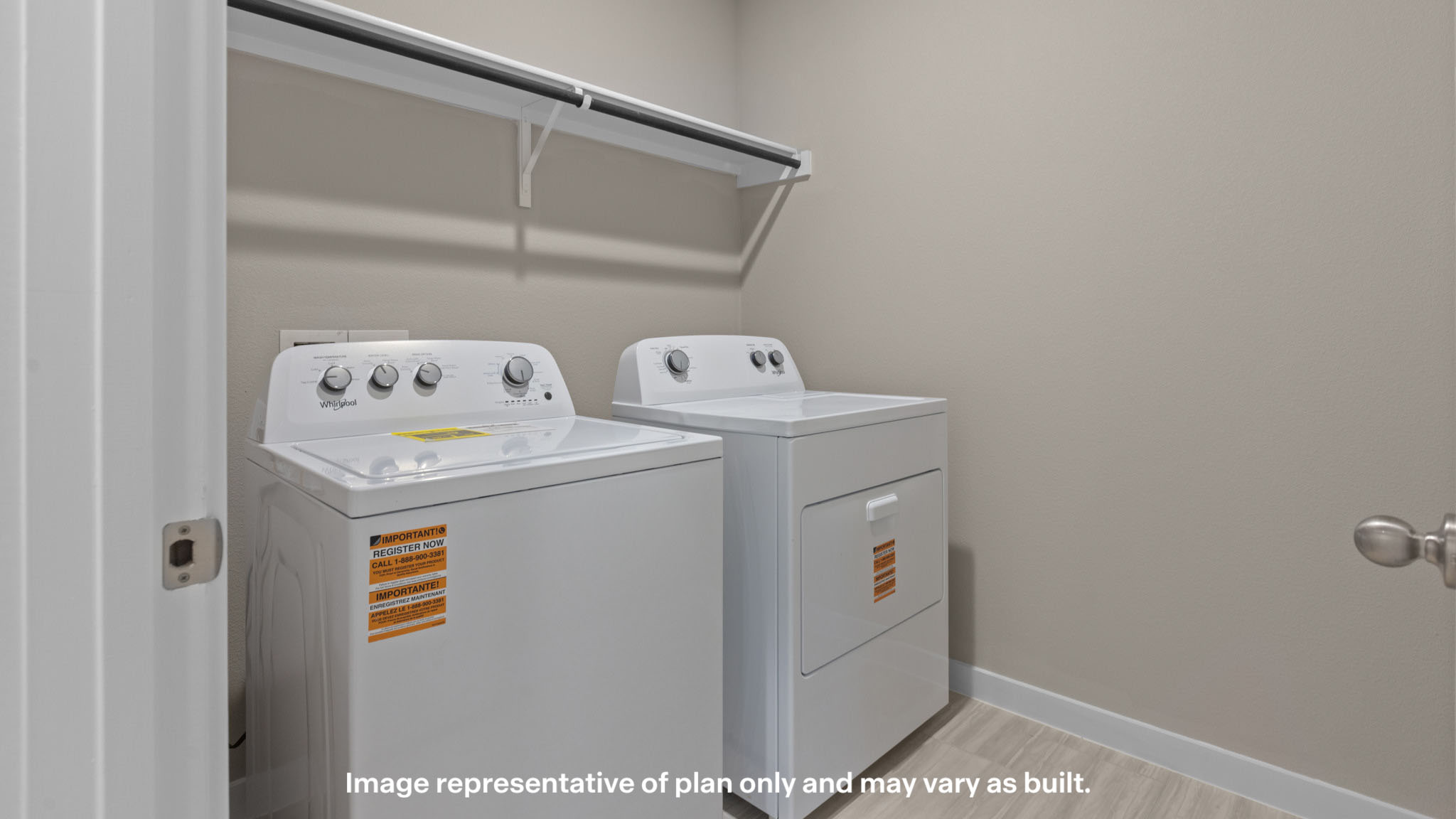 Convenient laundry room complete with washer and dryer connections, overhead shelving, and dedicated space for storage and organization.