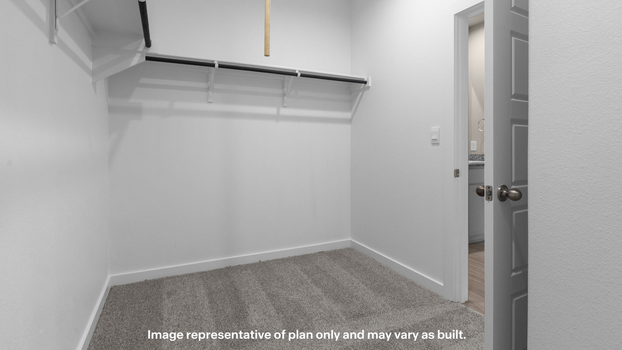 A spacious walk-in closet offers abundant storage to keep your wardrobe organized and within reach.