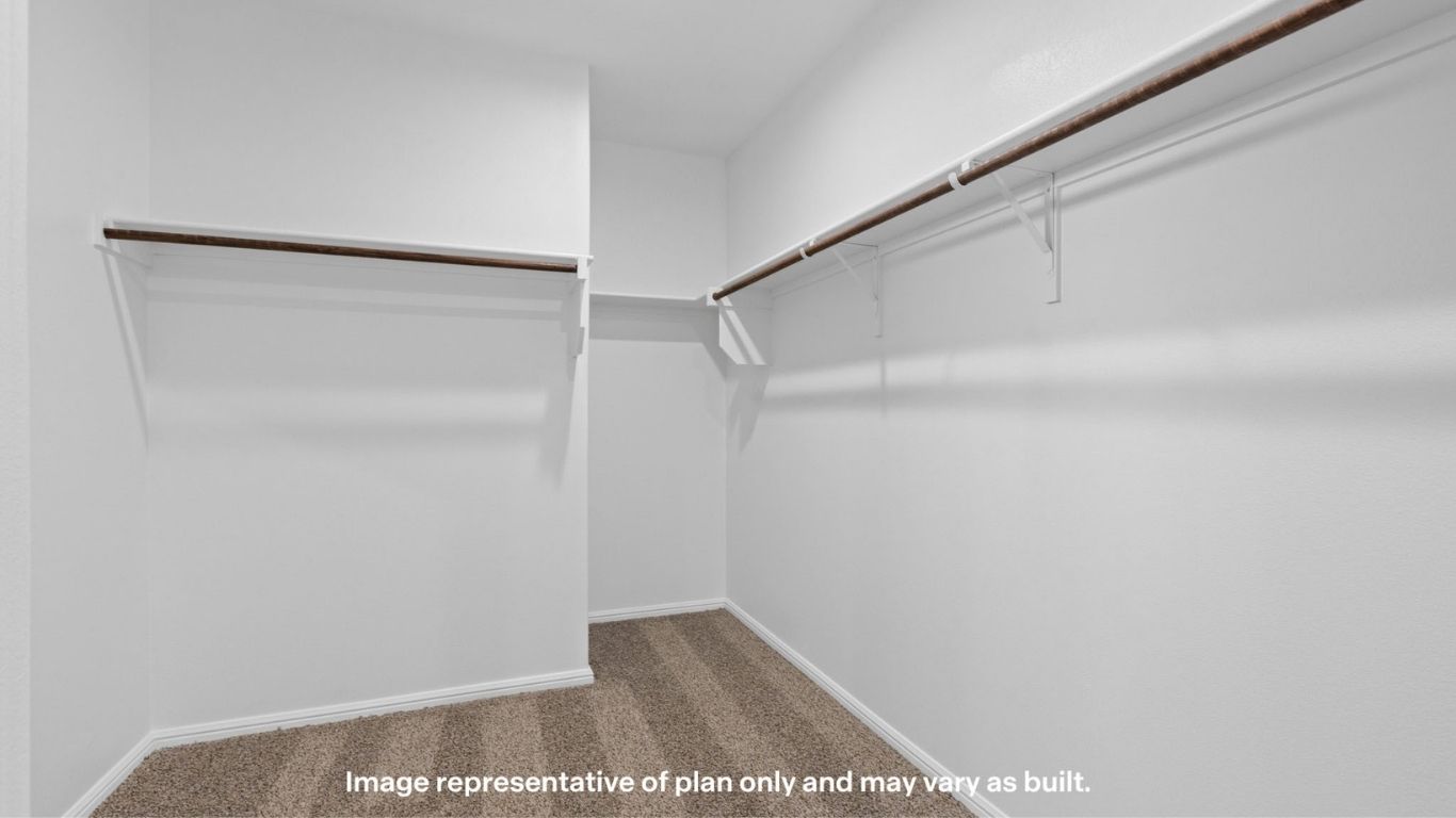 Walk-in closet with built-in shelving and ample storage space.
