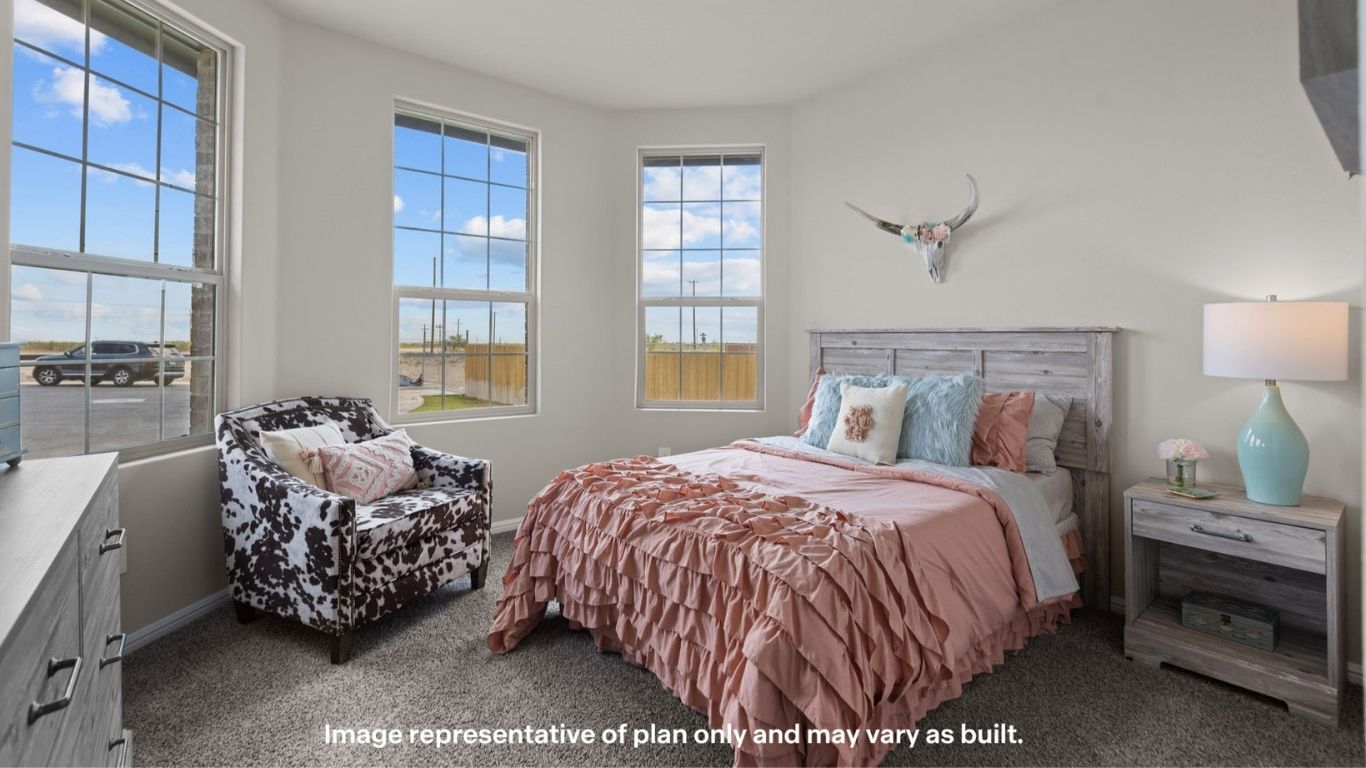 Secondary bedroom with large windows and bright natural light.