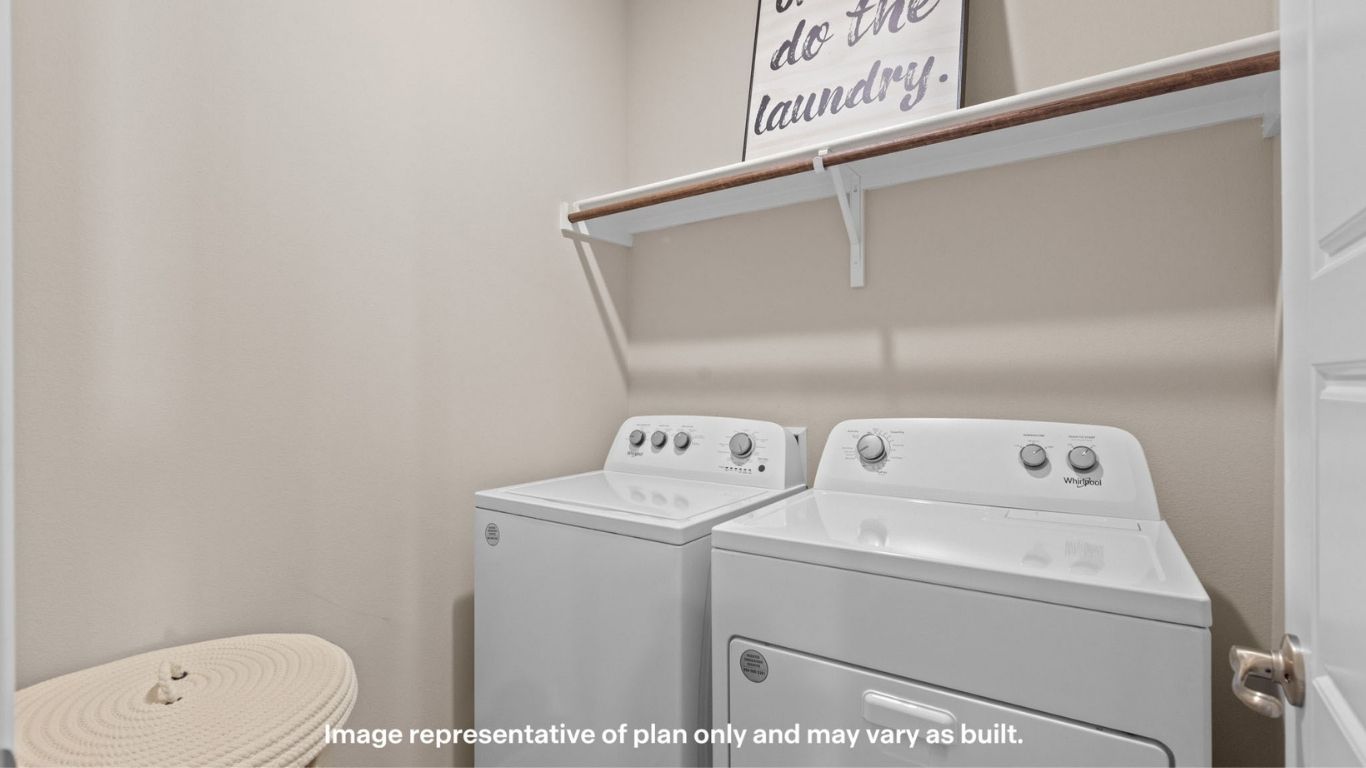 Close-up of laundry area with overhead shelf and appliances.