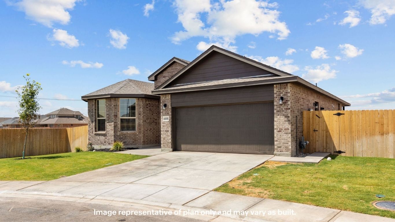 Angled exterior view highlighting curb appeal and extended driveway.