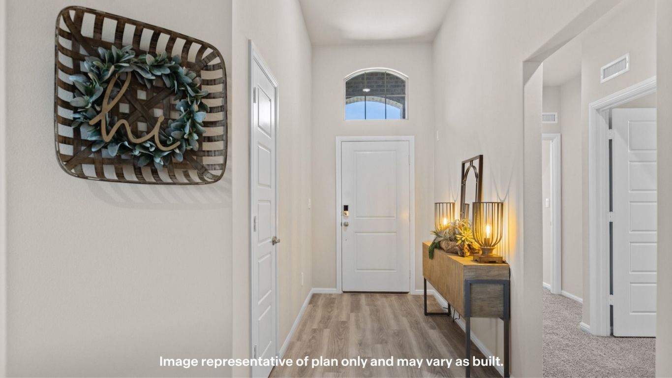 Welcoming entry hallway with high ceilings and natural light.