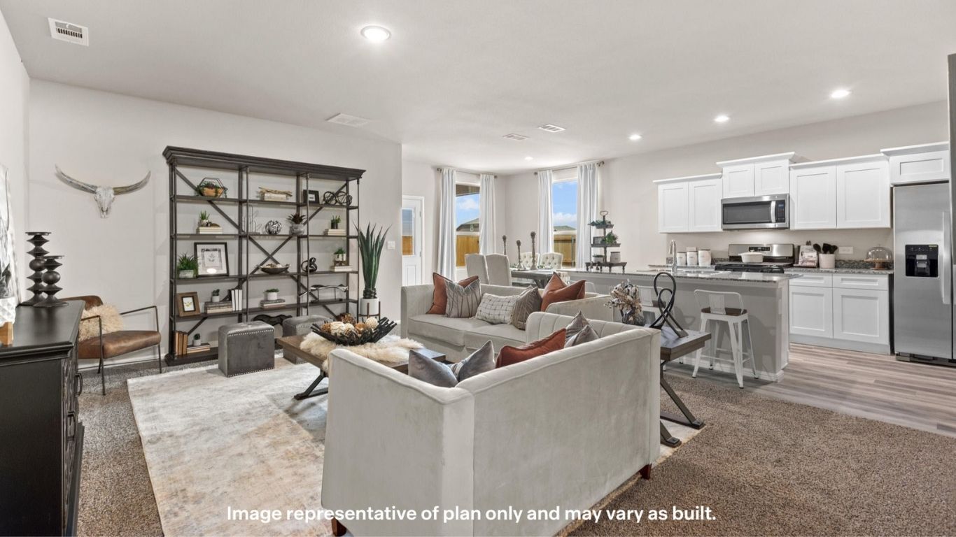 Bright living space with large windows and comfortable layout.