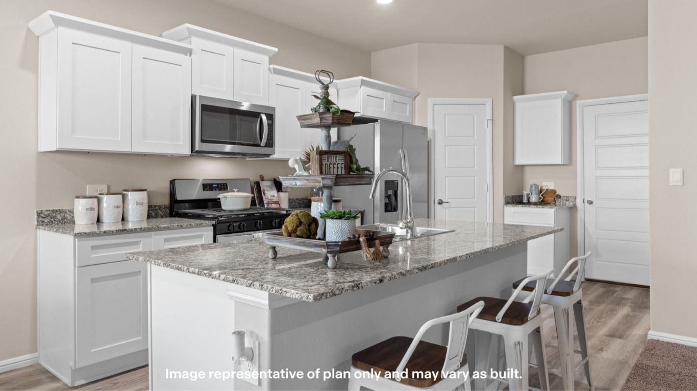 Open kitchen and dining area with natural light and backyard access.