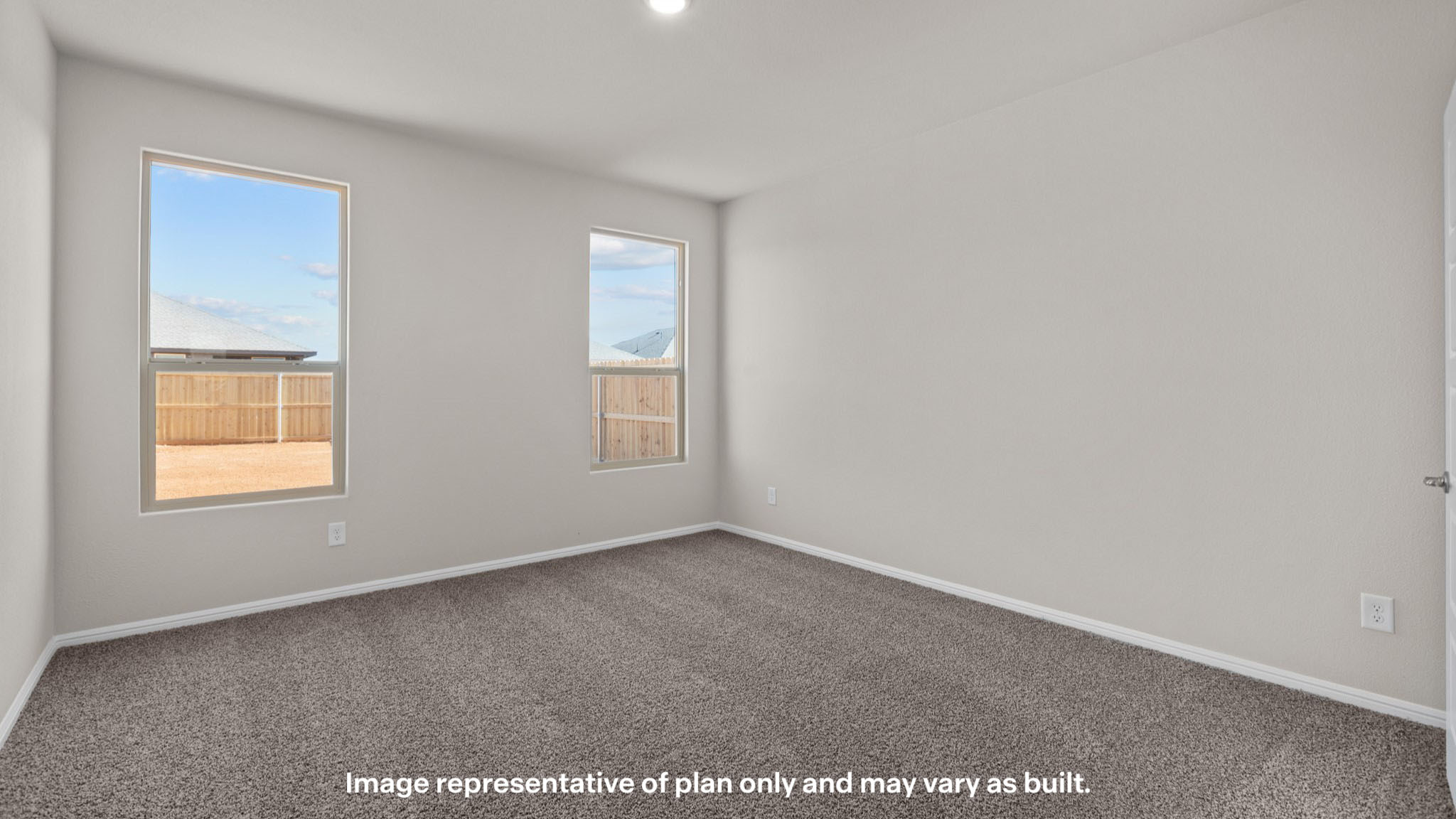 Primary bedroom with plush carpet floors and double light allowing windows