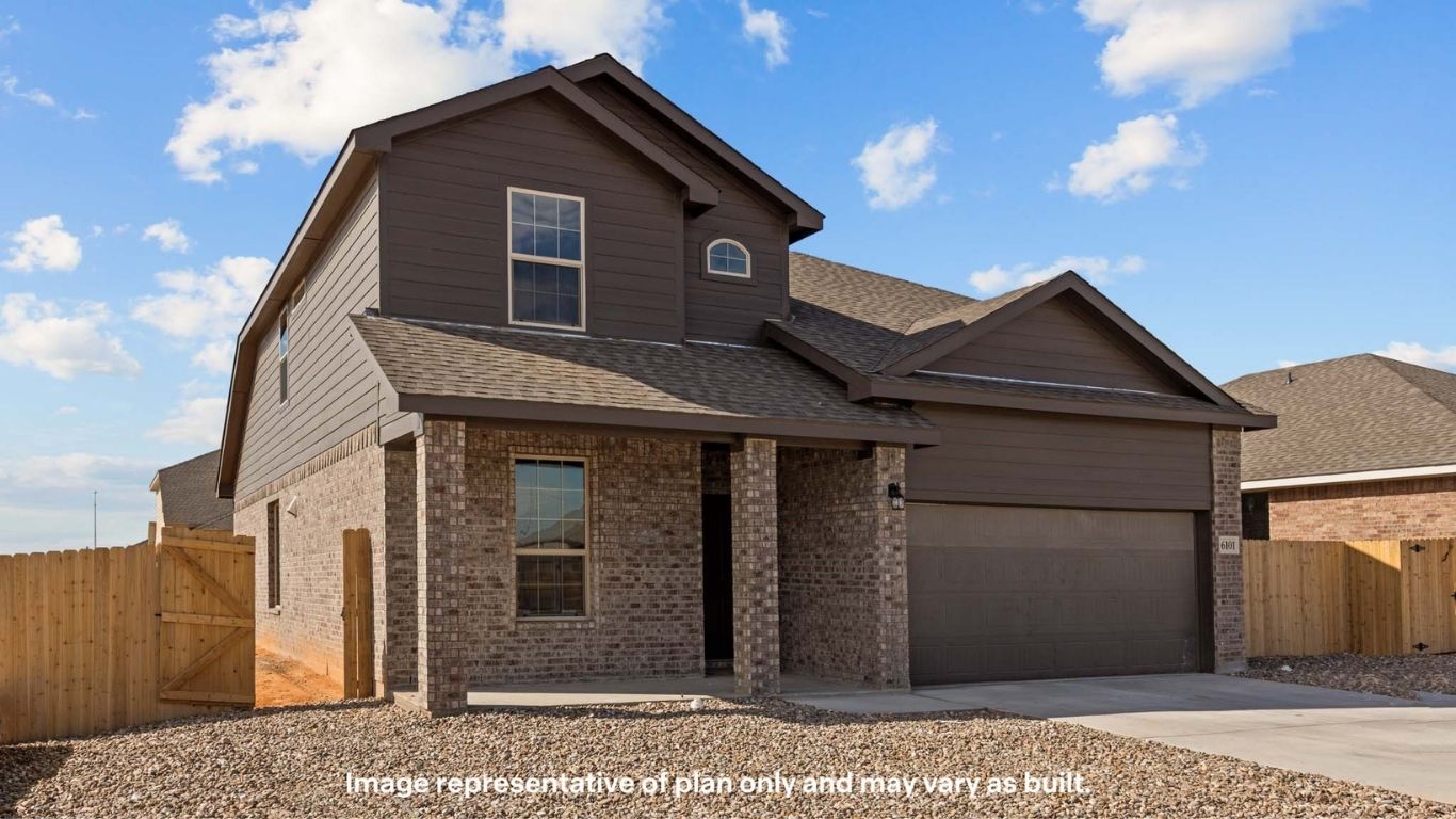 Side view of two story timeless brick home