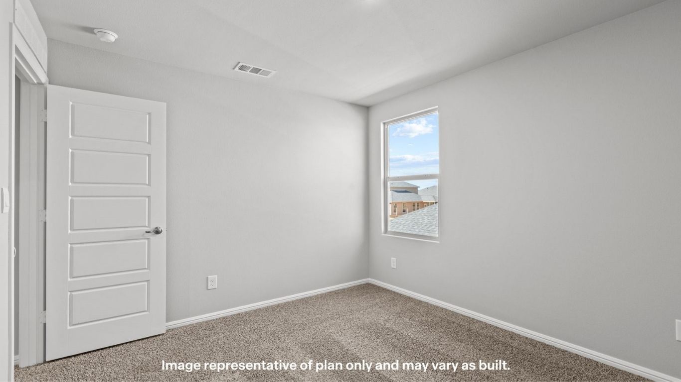 Upstairs guest bedroom 1 with plush carpet floors