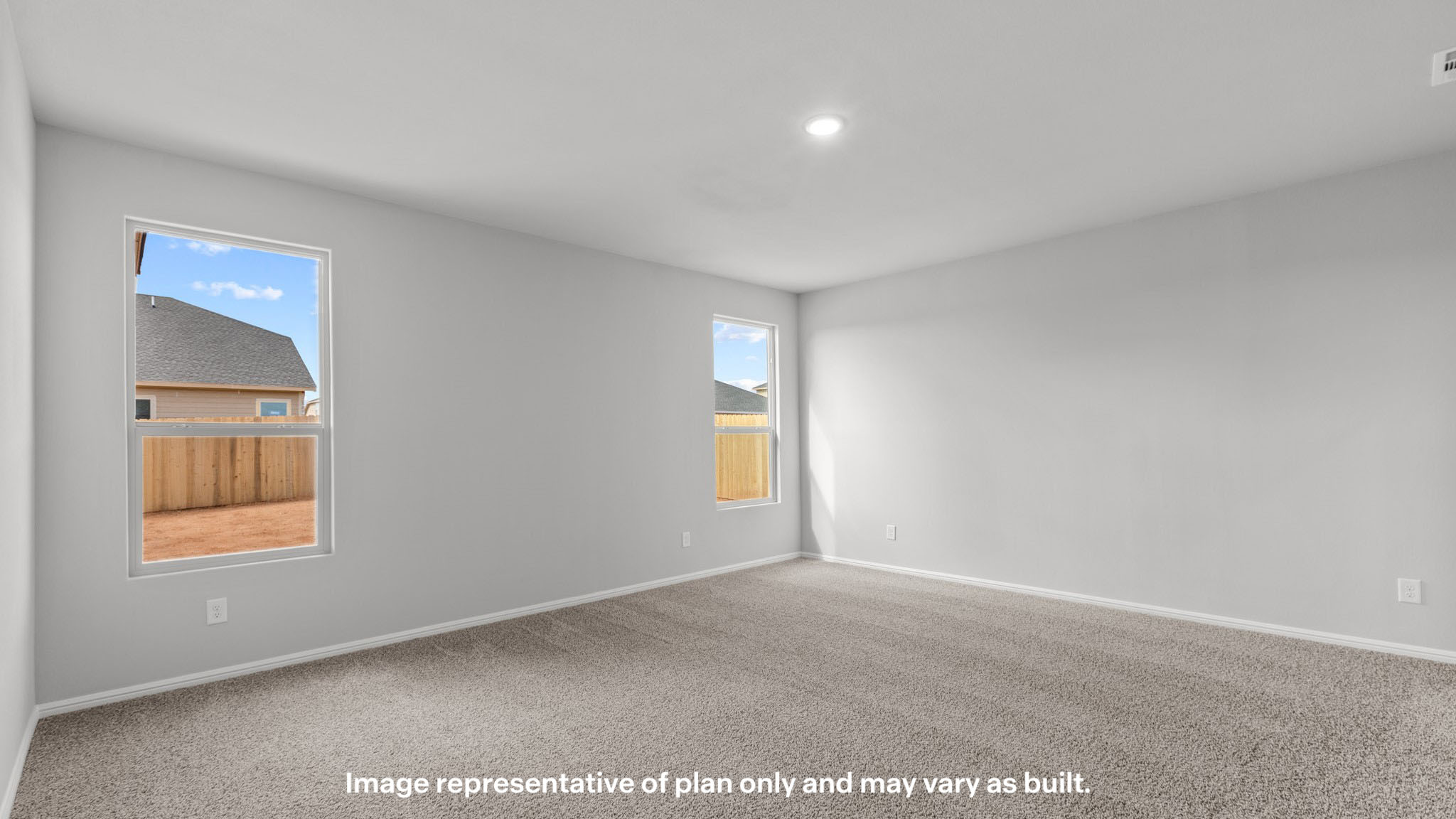 Primary bedroom with plush carpet floors and double light allowing windows