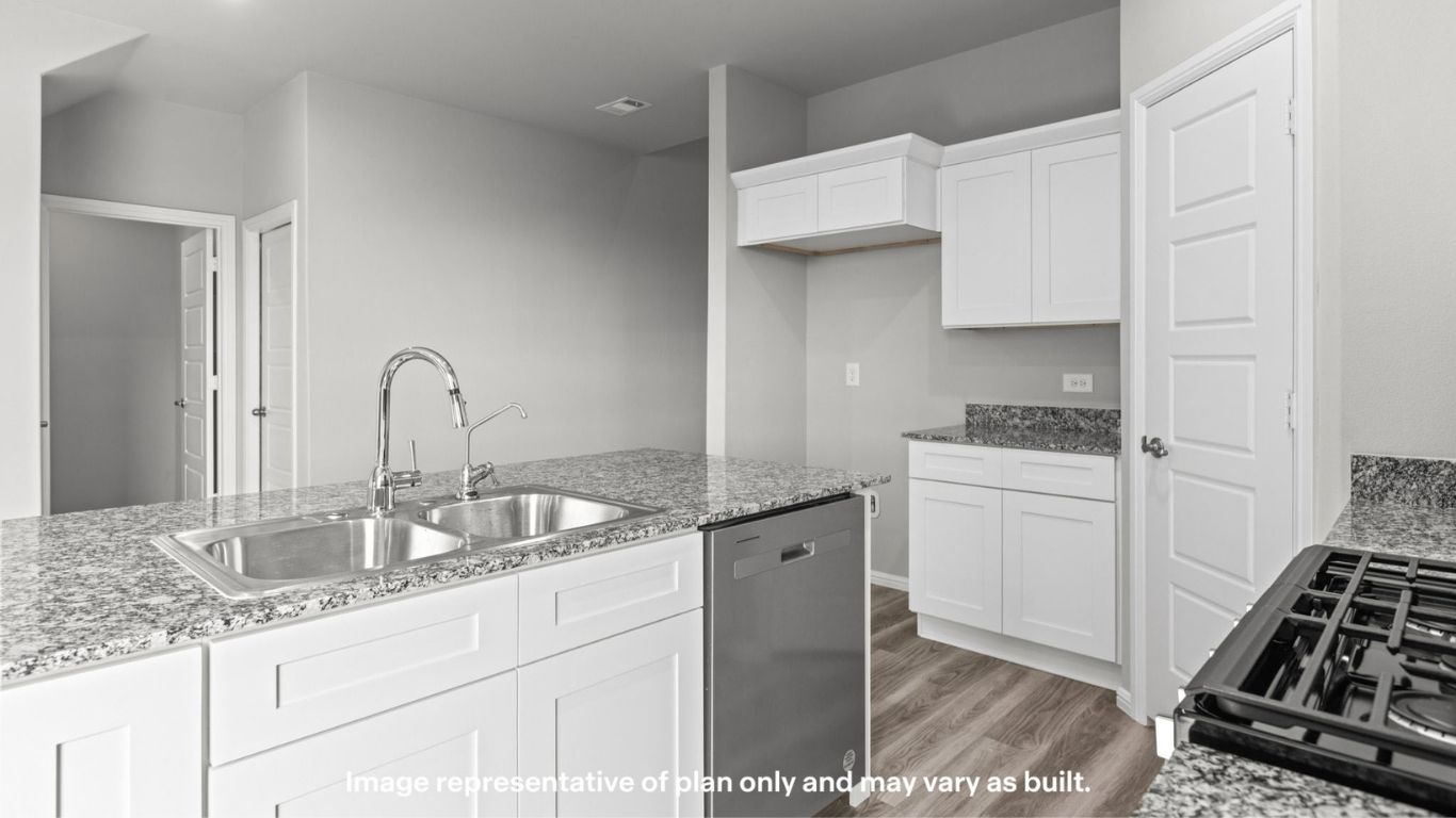 Kitchen island with double sink overlooking the main living area.