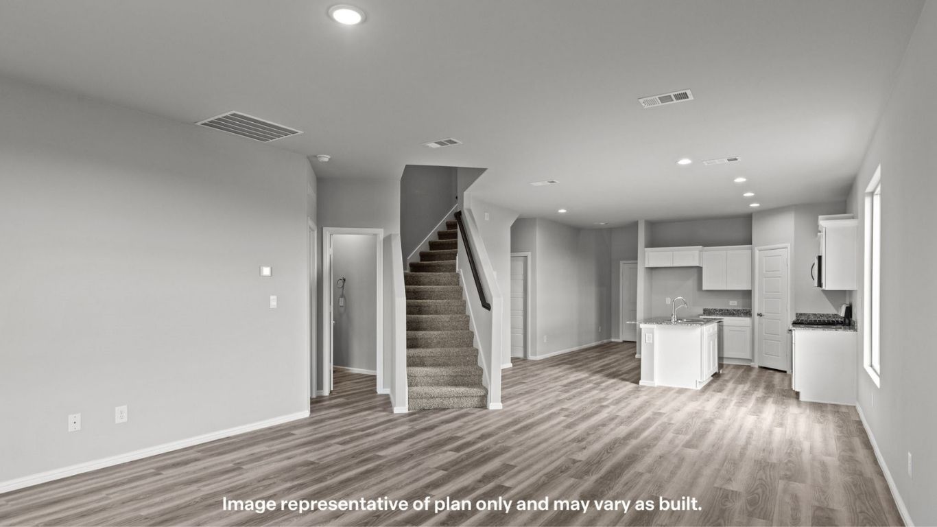Open-concept layout featuring staircase and expansive living area.