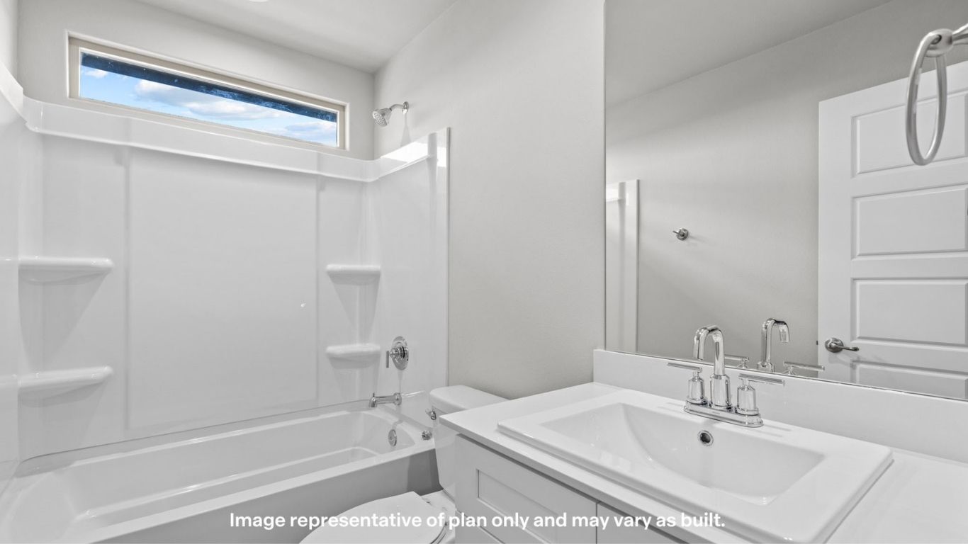 Full bathroom with tub/shower combo, bright white finishes, and a large mirror.
